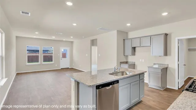 a view of kitchen with stainless steel appliances granite countertop refrigerator sink and stove
