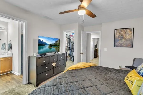 a bedroom with a bed and a flat screen tv