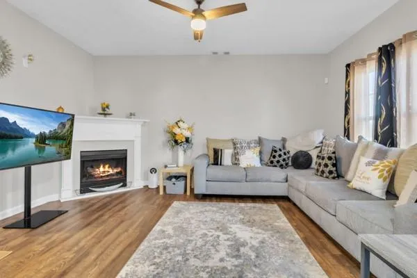 a living room with furniture and a fireplace