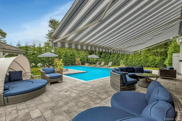 a view of a patio with couches chairs and a fire pit