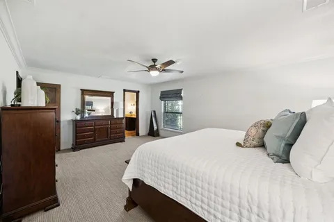 a bedroom with a large bed and dresser