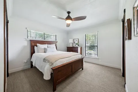 a spacious bedroom with a bed and a window