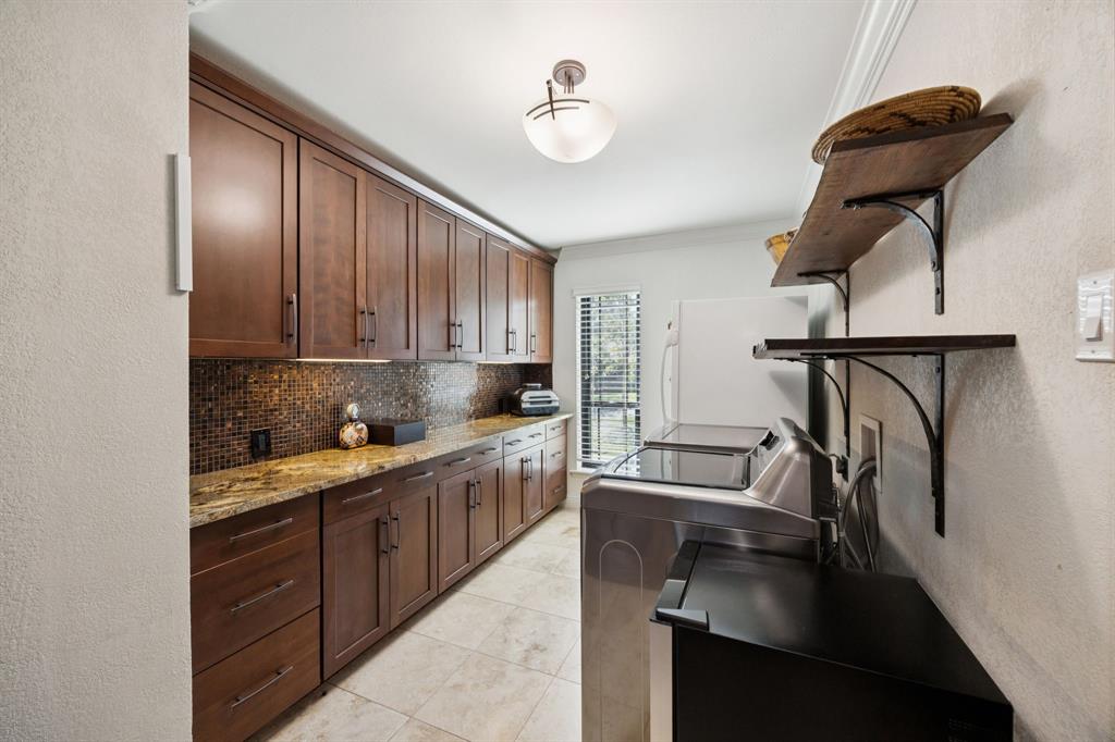 14380 Olympic Drive Farmers Branch, TX 75234 - Photo 23 of 33 a kitchen with stainless steel appliances granite countertop a sink refrigerator and cabinets
