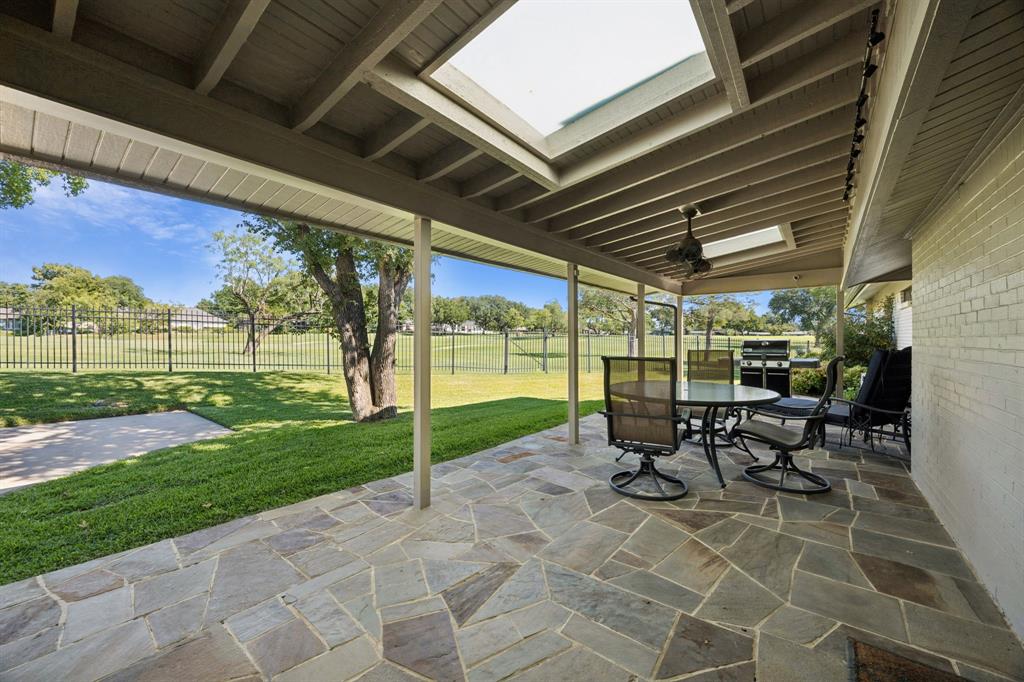 14380 Olympic Drive Farmers Branch, TX 75234 - Photo 27 of 33 a view of a patio with table and chairs and garden
