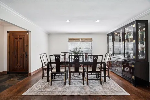 a view of a a dining room with furniture window and wooden floor
