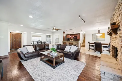 a living room with furniture and wooden floor