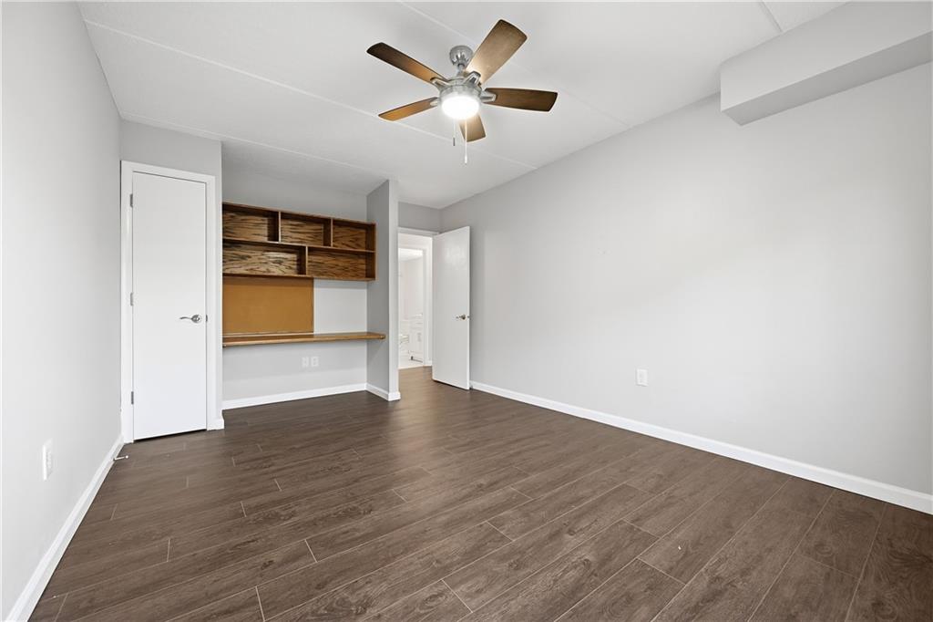 5600 Munhall Road, Unit 309 Pittsburgh, PA 15217 - Photo 18 of 40 an empty room with wooden floor and a ceiling fan