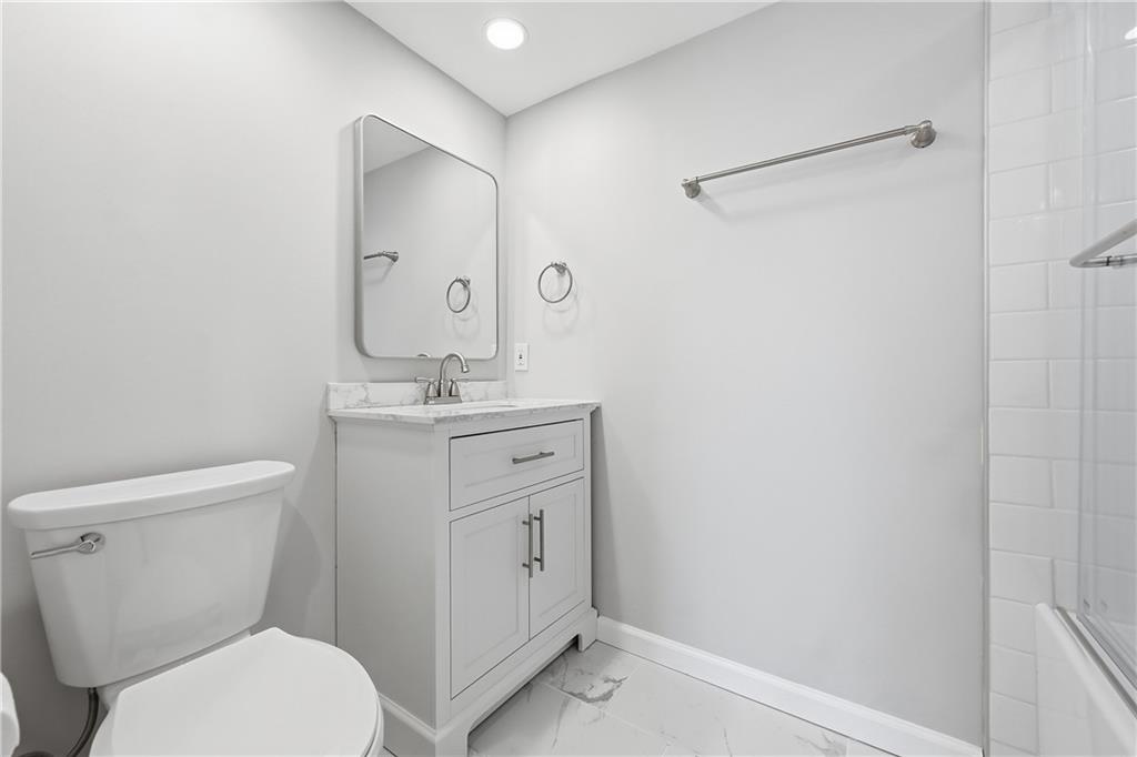 5600 Munhall Road, Unit 309 Pittsburgh, PA 15217 - Photo 25 of 40 a bathroom with a toilet sink vanity and mirror
