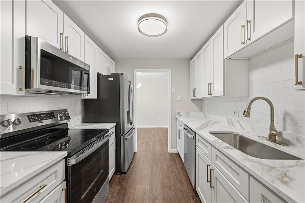 5600 Munhall Road, Unit 309 Pittsburgh, PA 15217 - Photo 8 of 40 a kitchen with stainless steel appliances granite countertop a stove microwave and a sink
