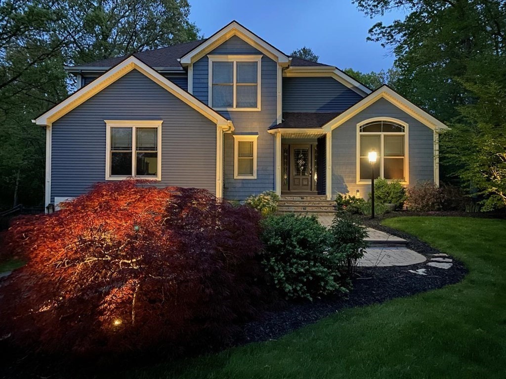 a front view of house with yard and green space
