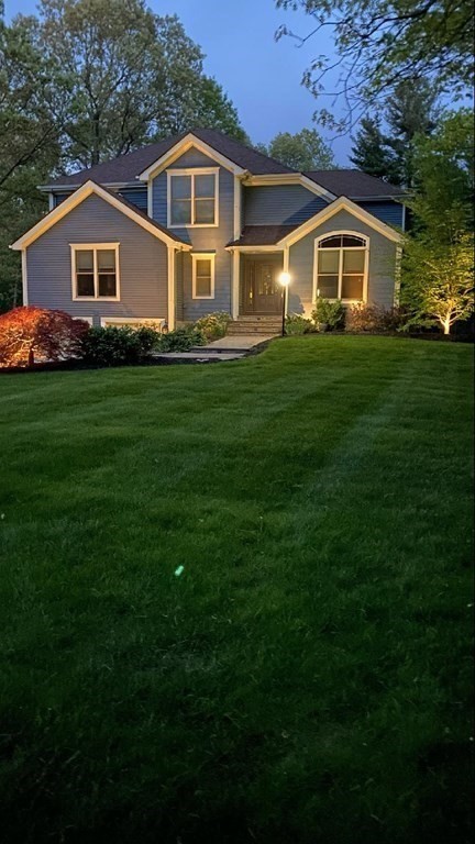 125 Brookside Drive Uxbridge, MA 01569 - Photo 2 of 40 a front view of a house with a garden