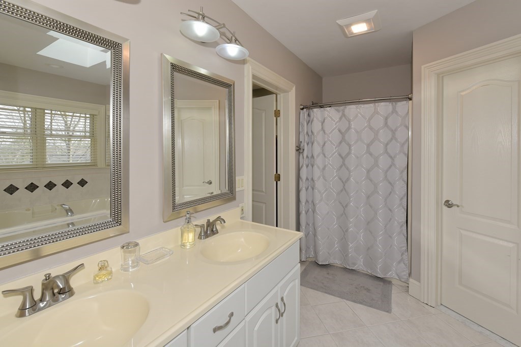 125 Brookside Drive Uxbridge, MA 01569 - Photo 27 of 40 a bathroom with a double vanity sink and a mirror