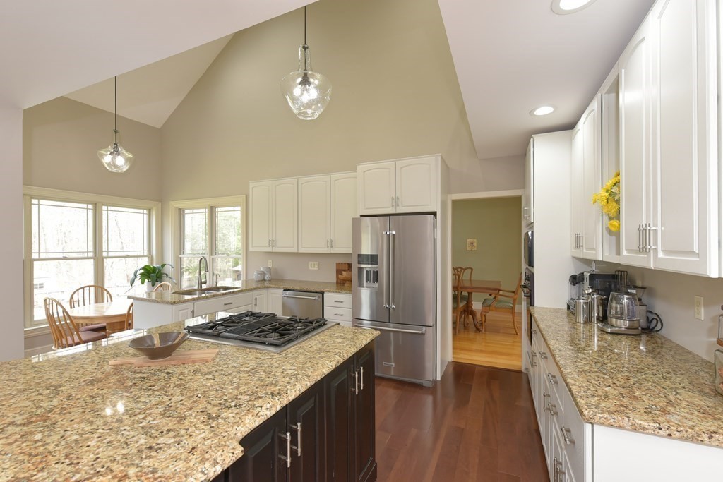 125 Brookside Drive Uxbridge, MA 01569 - Photo 8 of 40 a kitchen with stainless steel appliances granite countertop a sink stove and refrigerator