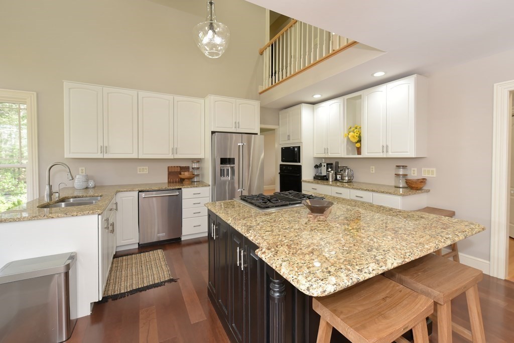 125 Brookside Drive Uxbridge, MA 01569 - Photo 10 of 40 a kitchen with stainless steel appliances granite countertop a sink stove and refrigerator