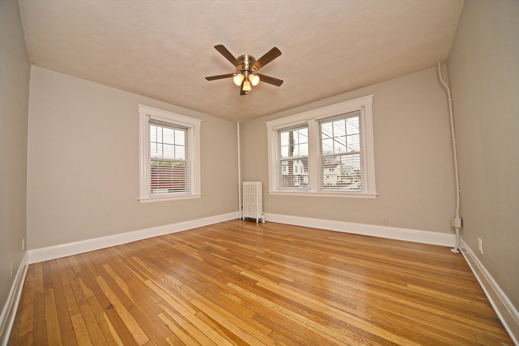 68 Linden Street, Unit 27 Everett, MA 02149 - Photo 3 of 13 a view of an empty room with wooden floor and a window