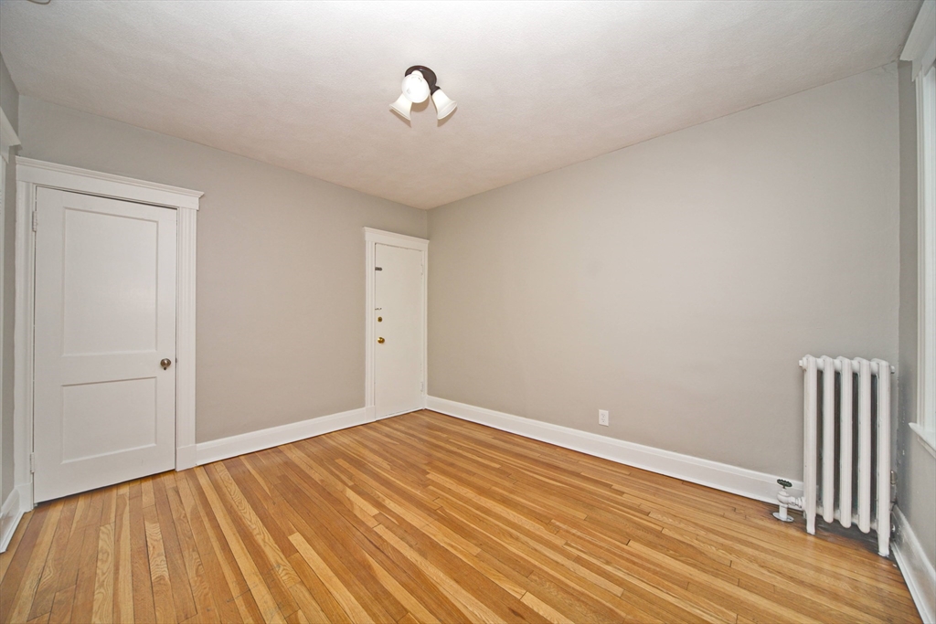 68 Linden Street, Unit 27 Everett, MA 02149 - Photo 6 of 13 a view of a room with wooden floor and white walls