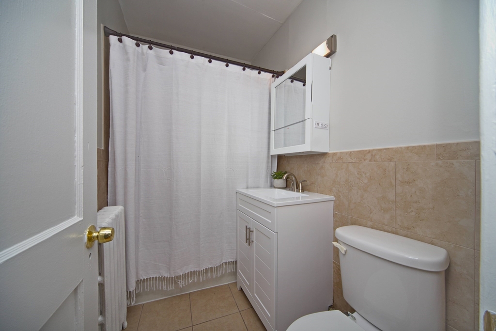 68 Linden Street, Unit 27 Everett, MA 02149 - Photo 7 of 13 a bathroom with a sink a toilet and shower