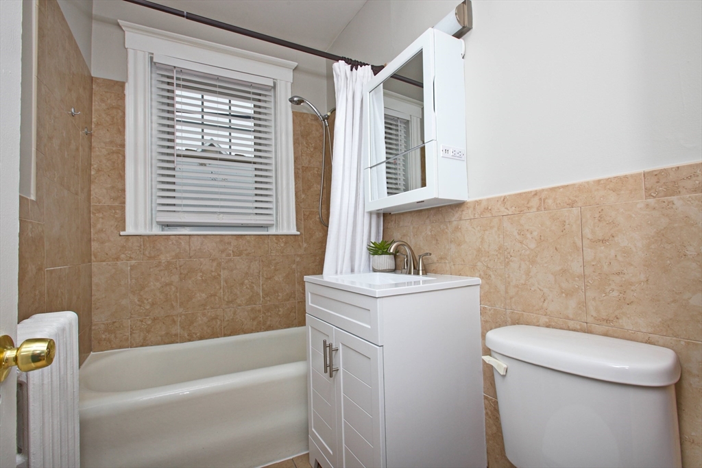 68 Linden Street, Unit 27 Everett, MA 02149 - Photo 8 of 13 a bathroom with a sink a toilet and a bathtub
