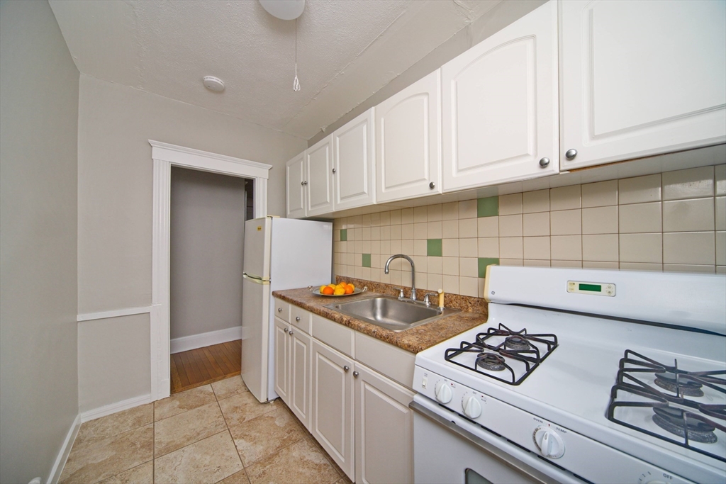 68 Linden Street, Unit 27 Everett, MA 02149 - Photo 10 of 13 a kitchen with a stove and a refrigerator