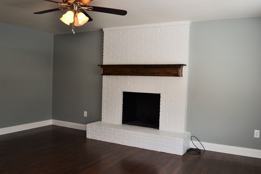 29 East Hill Road Springfield, MA 01109 - Photo 8 of 19 a living room with a fireplace and a ceiling fan