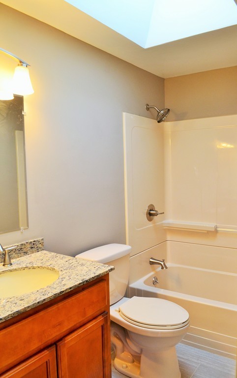 29 East Hill Road Springfield, MA 01109 - Photo 10 of 19 a bathroom with a granite countertop sink toilet and shower