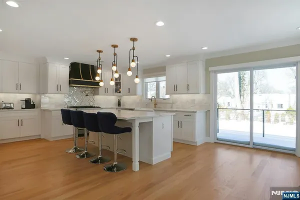 a kitchen with a sink cabinets and wooden floor