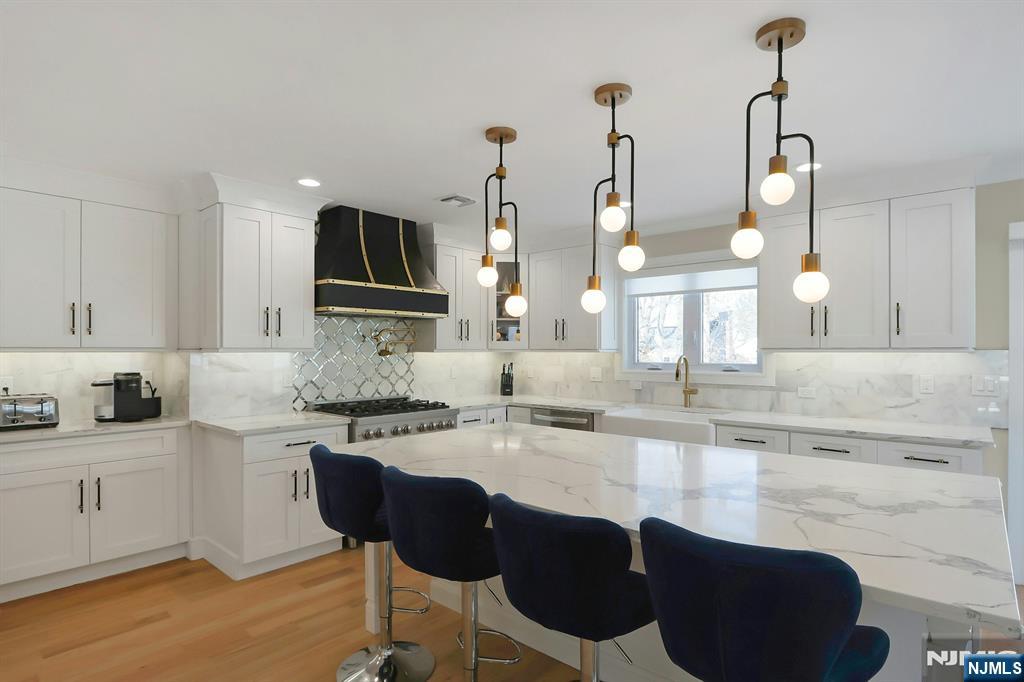 676 Ridgewood Avenue Oradell, NJ 07649 - Photo 16 of 47 a kitchen with granite countertop a sink cabinets and stainless steel appliances