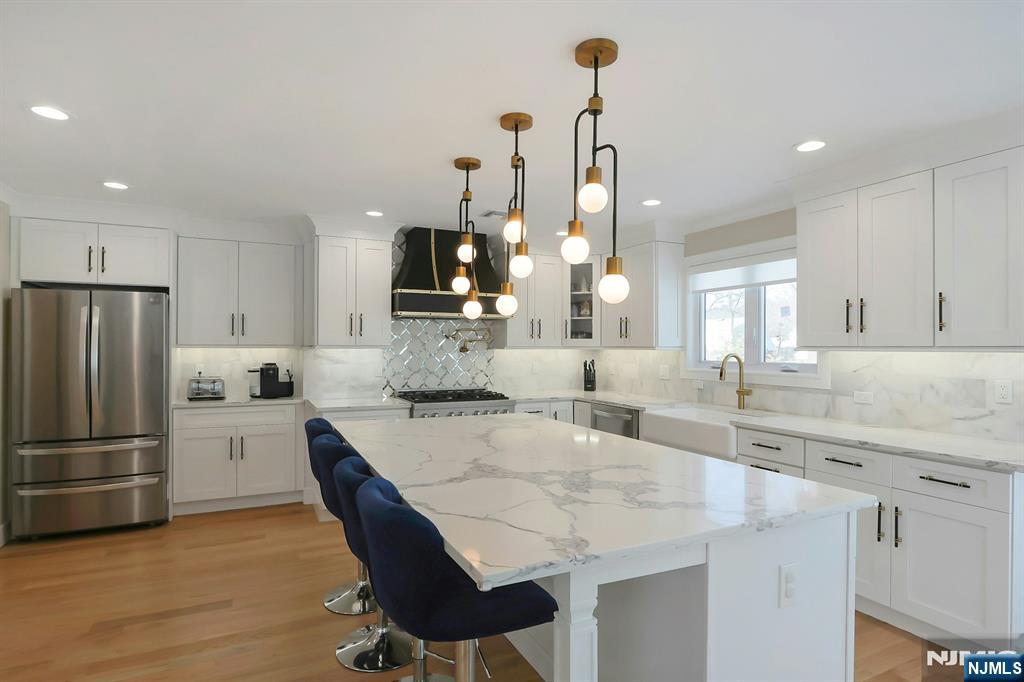 676 Ridgewood Avenue Oradell, NJ 07649 - Photo 18 of 47 a large kitchen with granite countertop a counter top space appliances and cabinets