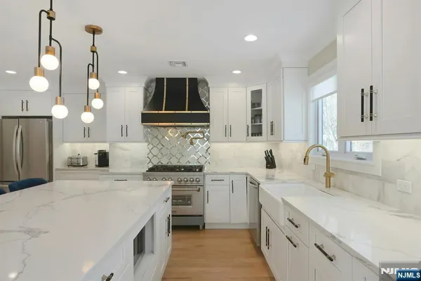 a kitchen with a sink stainless steel appliances and cabinets