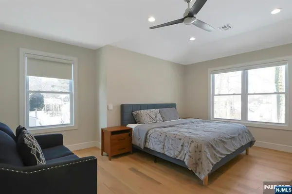 a bedroom with a bed and wooden floor