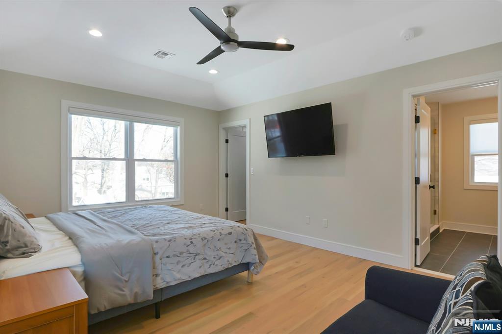 676 Ridgewood Avenue Oradell, NJ 07649 - Photo 27 of 47 a bedroom with a bed and a flat screen tv