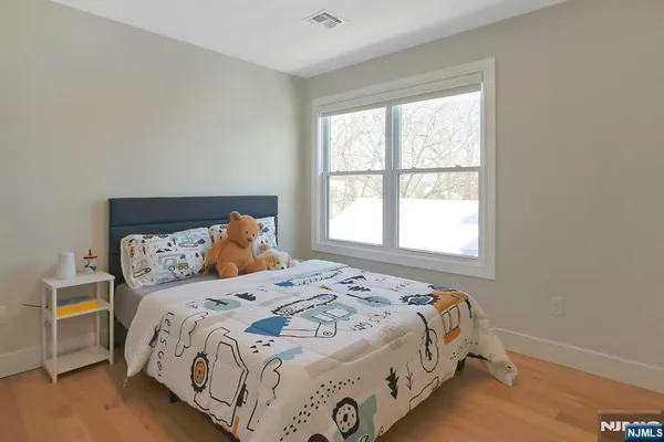 a bedroom with a bed and window