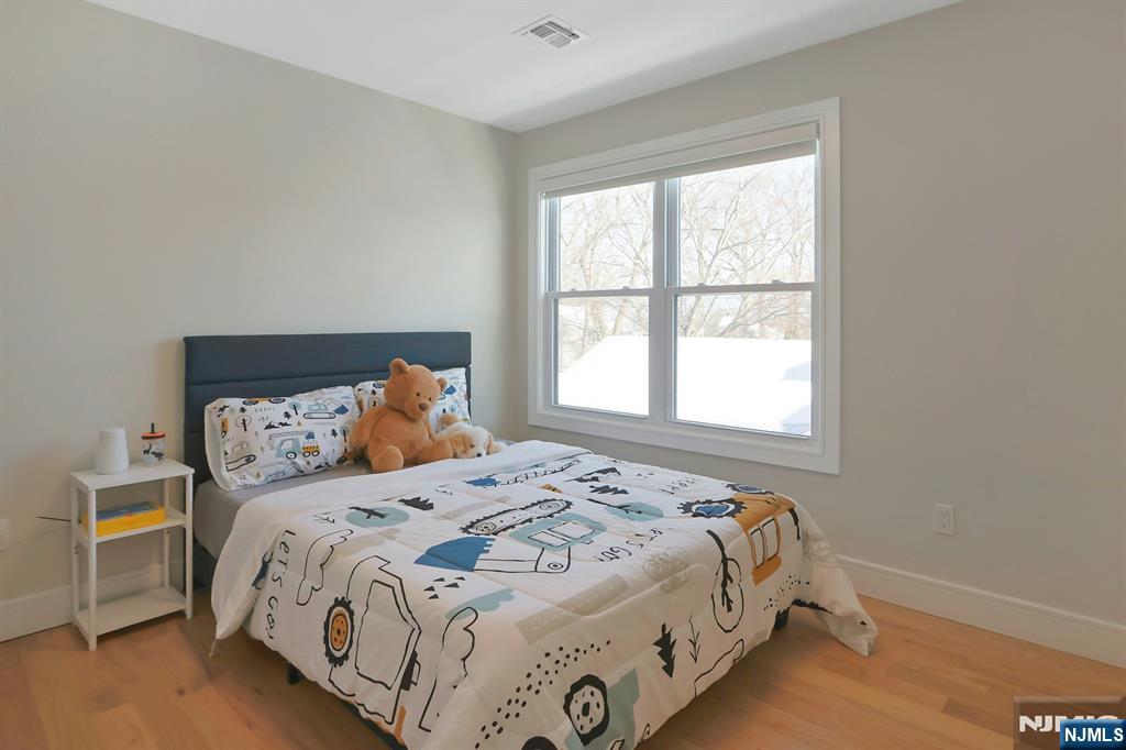 676 Ridgewood Avenue Oradell, NJ 07649 - Photo 31 of 47 a bedroom with a bed and window
