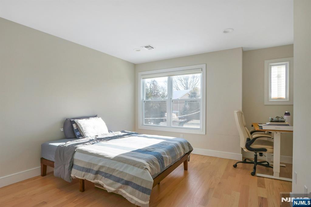 676 Ridgewood Avenue Oradell, NJ 07649 - Photo 33 of 47 a bedroom with a bed and a window