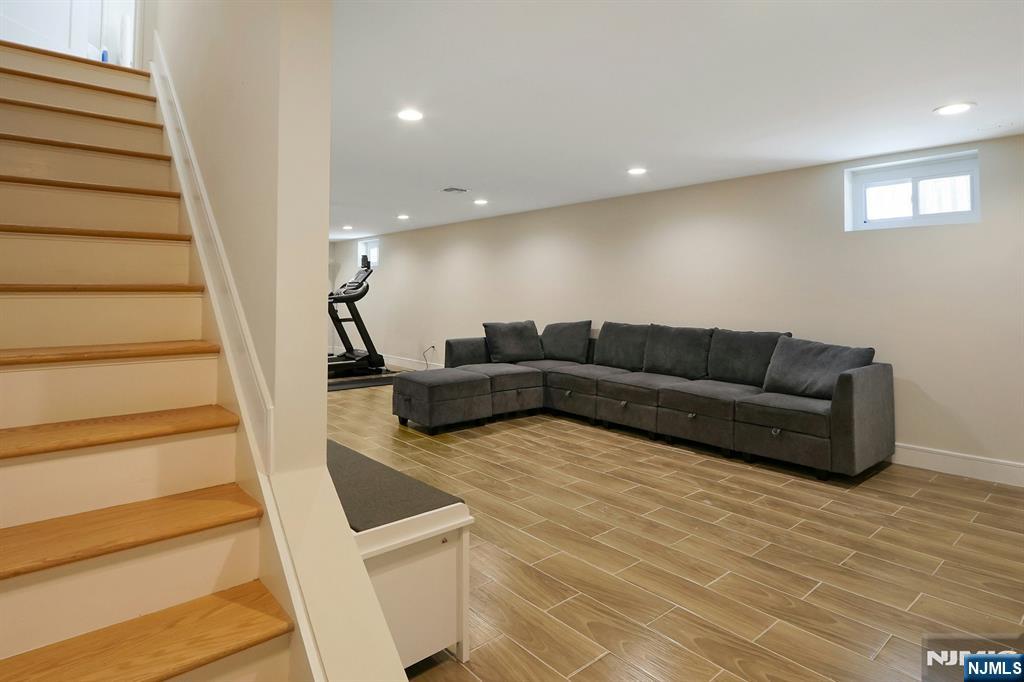 676 Ridgewood Avenue Oradell, NJ 07649 - Photo 37 of 47 a living room with furniture and a stair