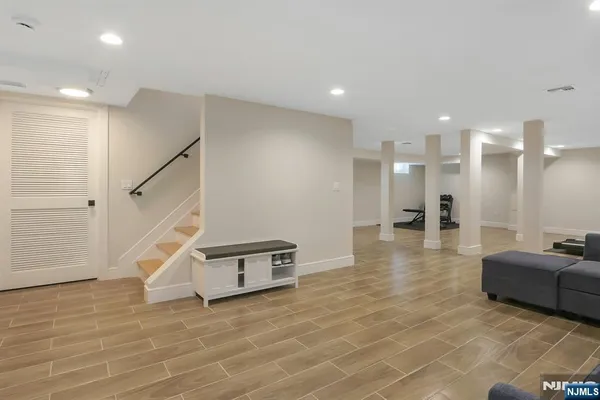 a view of a living room with furniture and a ceiling fan