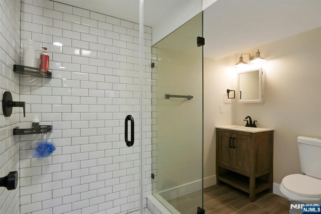 676 Ridgewood Avenue Oradell, NJ 07649 - Photo 42 of 47 a bathroom with a sink a toilet and shower