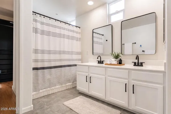 a bathroom with a sink a mirror and shower