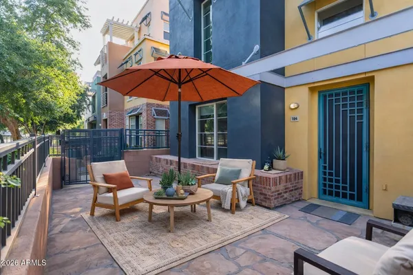 a backyard of a house with table and chairs