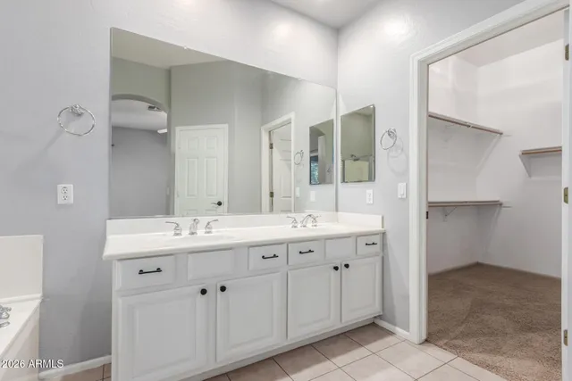 a bathroom with a double vanity sink and mirror