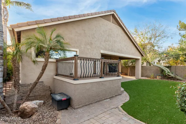 a view of a house with backyard and sitting area