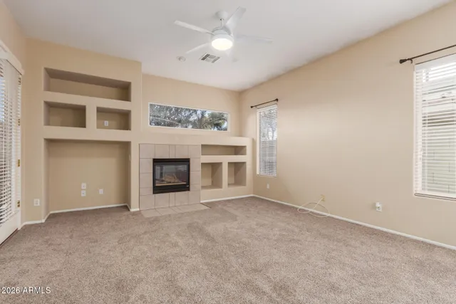 a view of a livingroom with a fireplace and a window