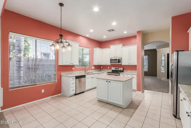 a kitchen with stainless steel appliances granite countertop a stove and a sink