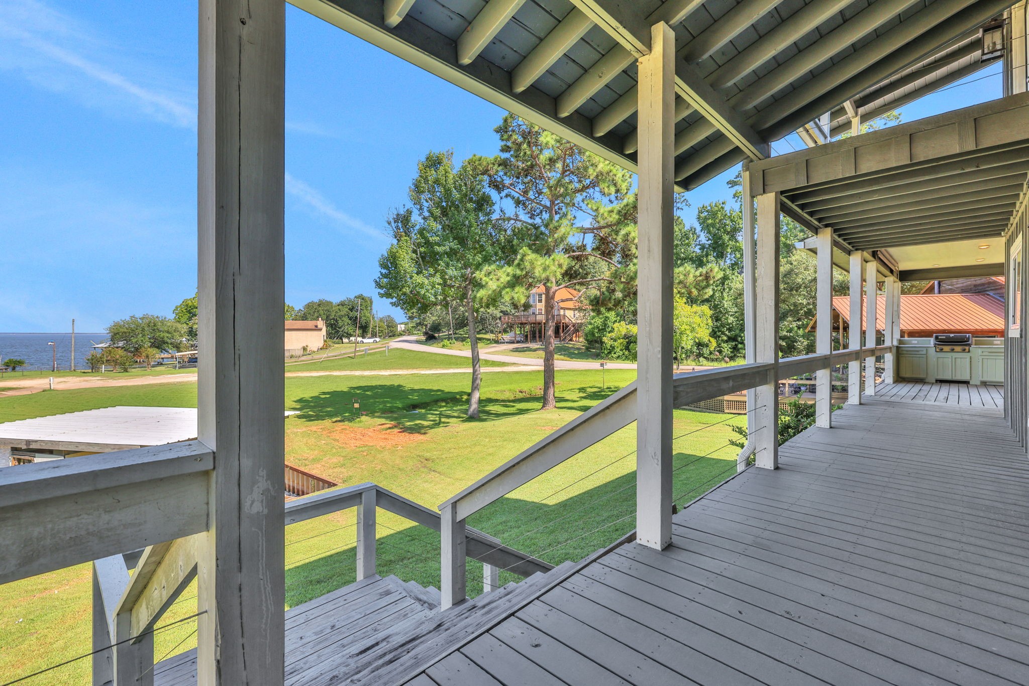 20 Ridgeway Drive Coldspring, TX 77331 - Photo 28 of 40 The deck wraps around to the doors of the living area and leads down for easy access to the water and boathouse.