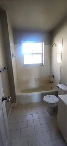 a bathroom with a toilet a sink and bathtub