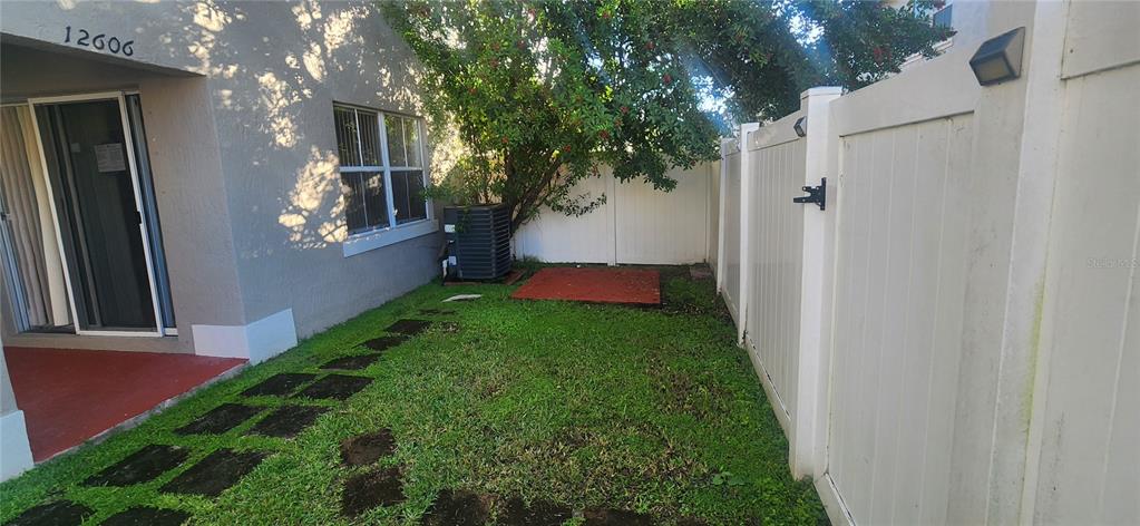12606 Southwest 53rd Street Miramar, FL 33027 - Photo 13 of 13 a view of yard from a corridor