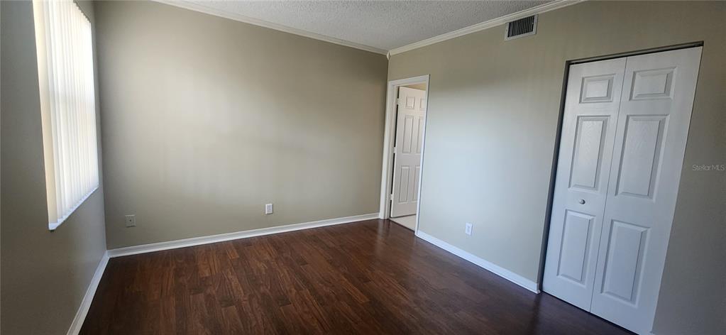 12606 Southwest 53rd Street Miramar, FL 33027 - Photo 9 of 13 an empty room with wooden floor and windows