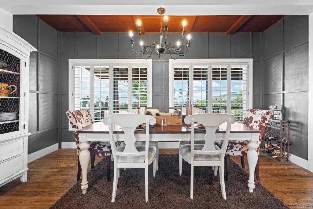 812 Sharon Way El Cajon, CA 92020 - Photo 12 of 65 a dining room with wooden floor a chandelier a glass table and chairs