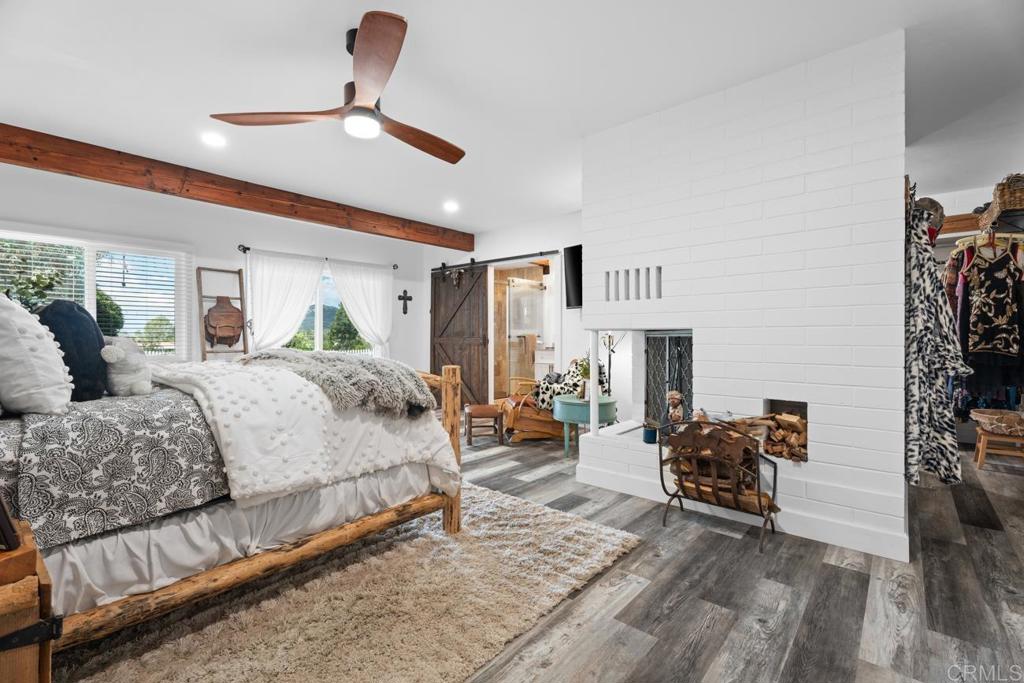 812 Sharon Way El Cajon, CA 92020 - Photo 19 of 65 a spacious bedroom with a bed couch and a ceiling fan