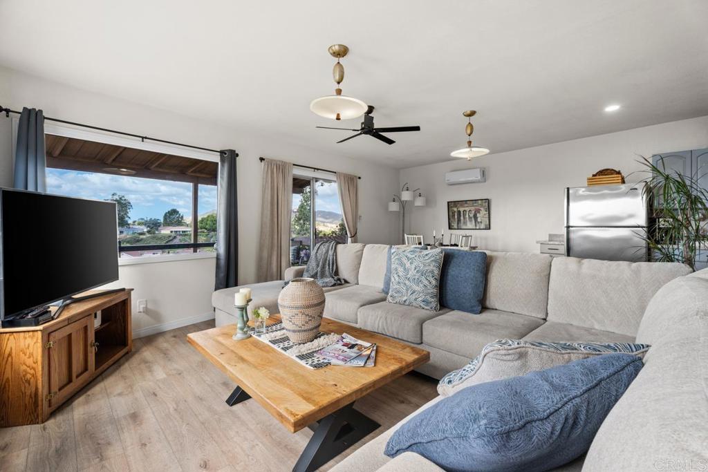 812 Sharon Way El Cajon, CA 92020 - Photo 55 of 65 a living room with furniture a flat screen tv and kitchen view